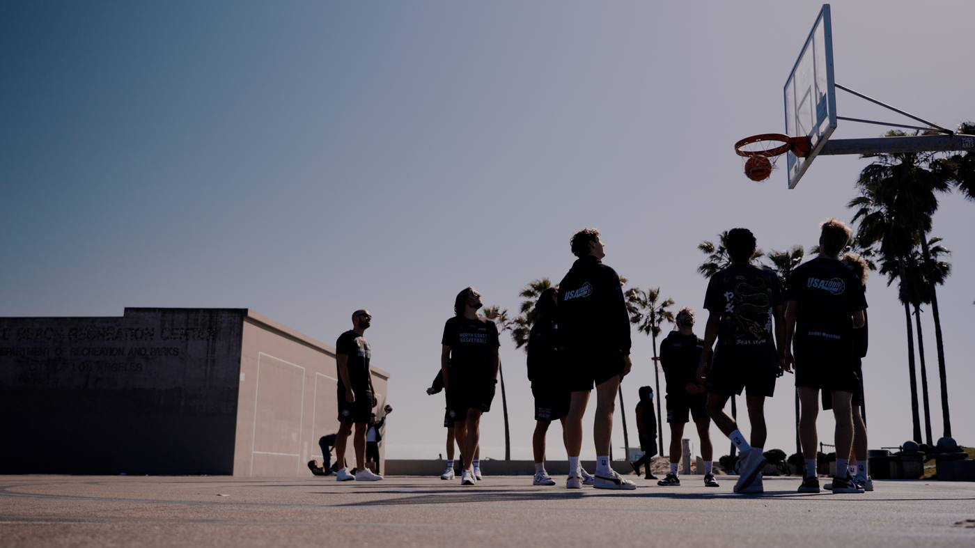 North Coast Basketball team silhouetted at Venice Beach outdoor court